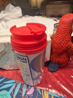 a "Design Your Own" travel mug featuring a colorful hot air balloon graphic a